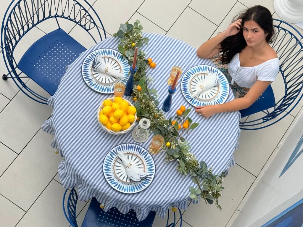 Top-down view of a blue-and-white table setting with lemons and decor.