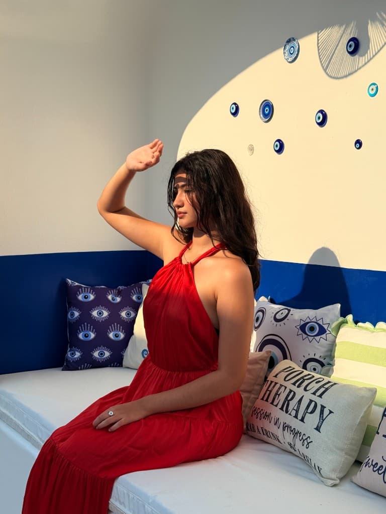 Lounge area with blue seating, decorative pillows, and wall ornaments.